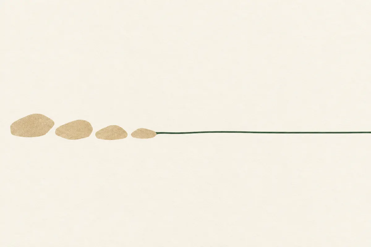A short sand-coloured path of four stepping stones leading into a long green line that stretches across the frame