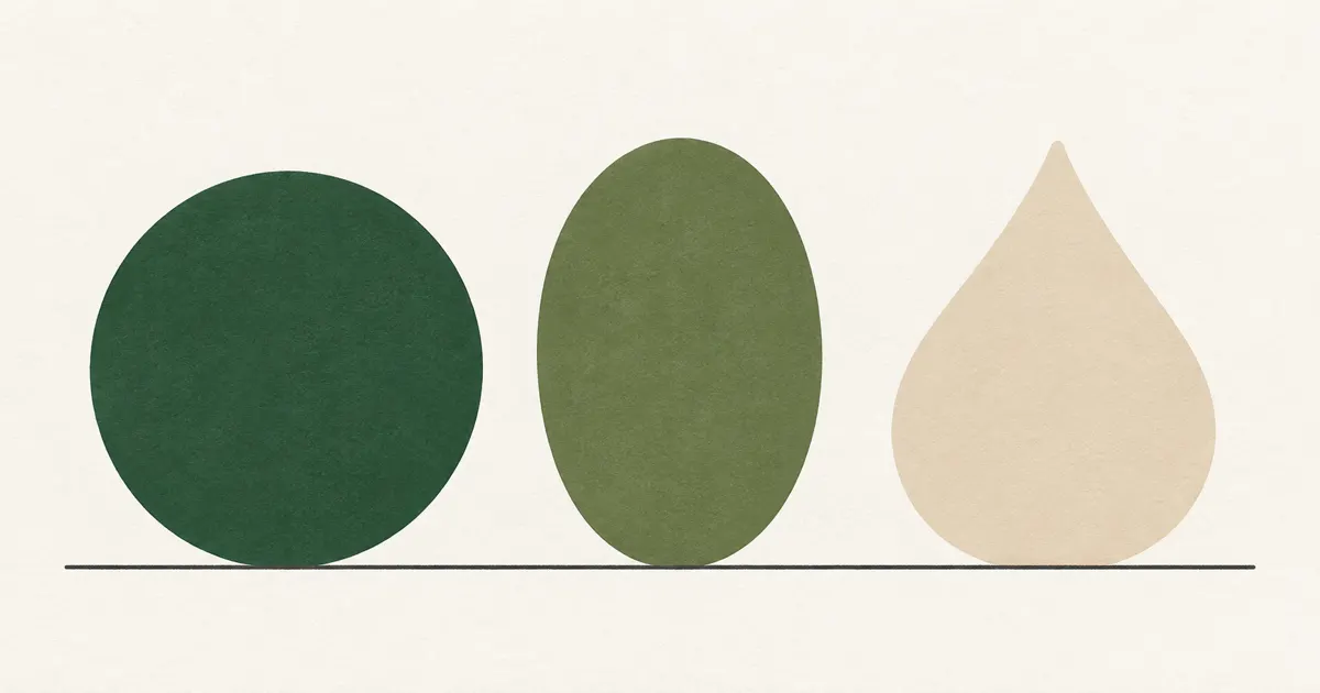 A circle, an oval and a droplet shape in green and sand on a line